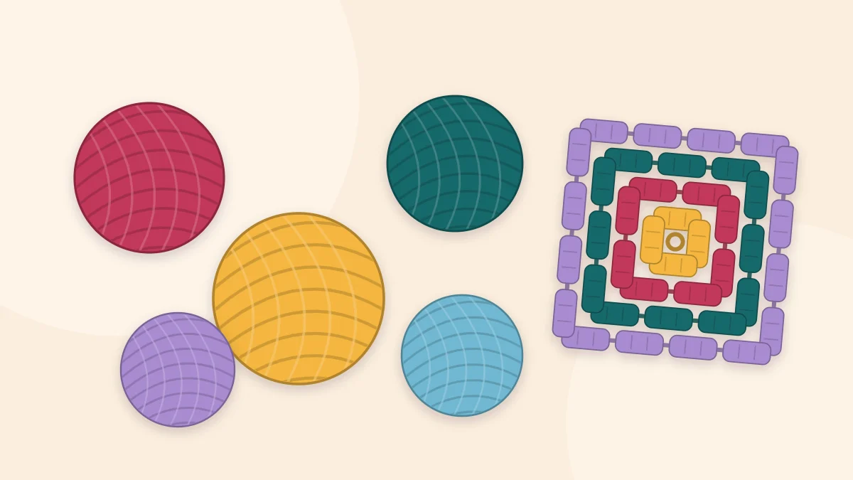 Several balls of yarn in different colors arranged around one finished granny square