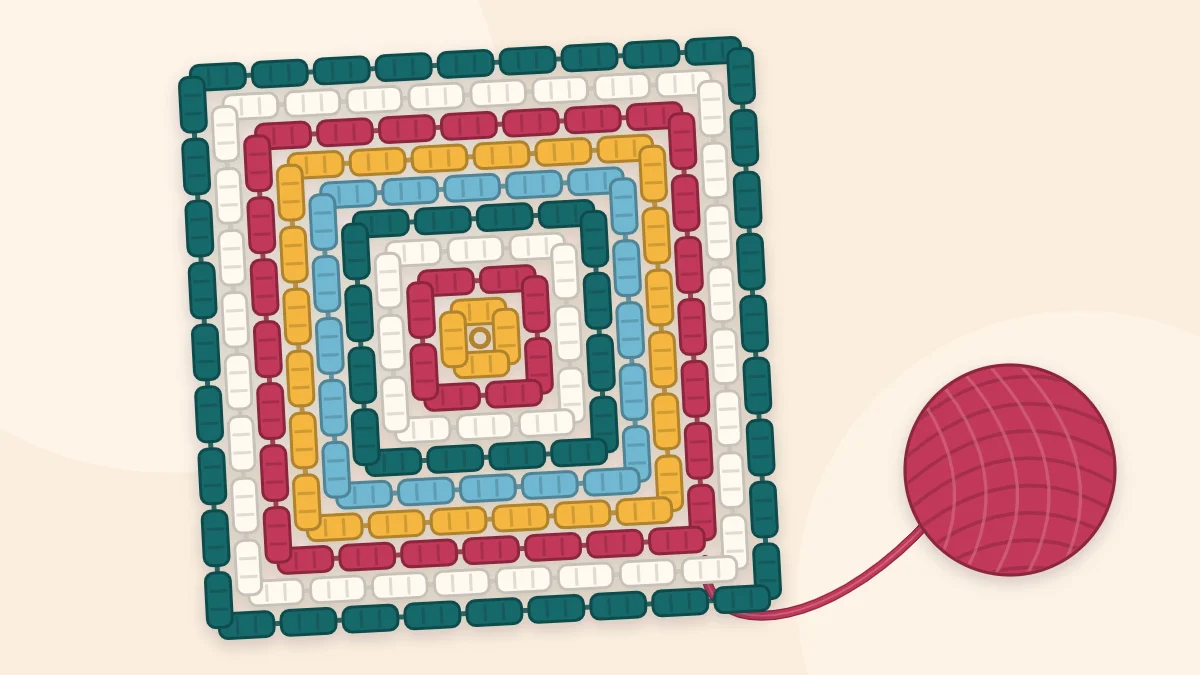 One very large granny square blanket with many striped rounds in different colors and a ball of yarn still attached at one corner