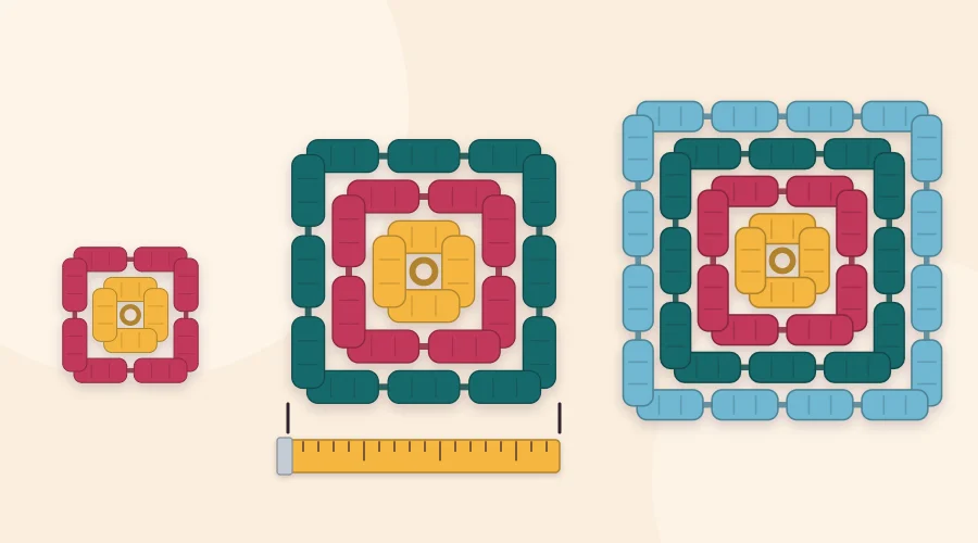 A ruler laid across the middle of a granny square from side to side, with a smaller and a larger square beside it